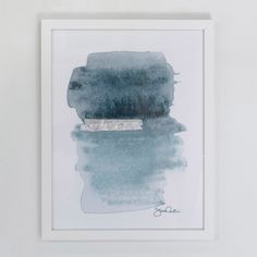 a watercolor painting hanging on the wall next to a white framed artwork piece with a silver strip