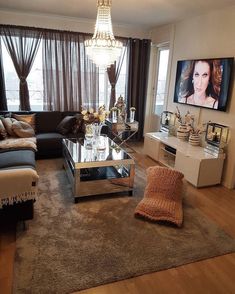 a living room filled with furniture and a flat screen tv mounted to the side of a wall