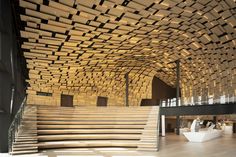 the inside of a building with wooden stairs