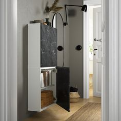 an open door leading into a white room with bookshelves and shelves on the wall