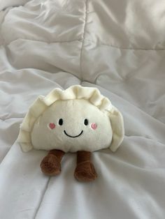 a stuffed animal that is sitting on a bed