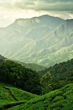 the words be awesome are written in white on top of green hills and trees with mountains in the background