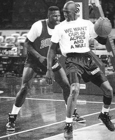 two men are playing basketball on the court