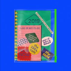 a spiral notebook with stickers on it and the words 2013 written in different languages