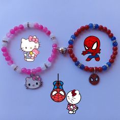 two bracelets with hello kitty and spiderman charms attached to them on a blue background