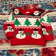 a red and white sweater with snowmen on it