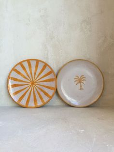 two plates sitting next to each other on top of a white tablecloth covered floor