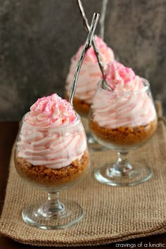 two desserts sitting on top of a table next to each other in wine glasses