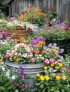 many different types of flowers are in buckets