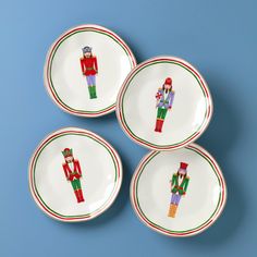 four plates with nutcrackers painted on them