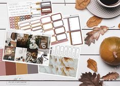 the contents of a fall planner spread out on a white table with autumn leaves and pumpkins