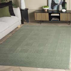 a living room with a couch, coffee table and rug