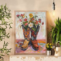 a painting of boots with flowers in them sitting on a shelf next to a potted plant