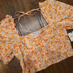 Nwt Arizona Jeans Co. Floral Sunched Ruffley Top With Puffy Like Sleeve. Has Front Tie Detail And One On The Back To Keep The Sleeves Higher If You Want. Reg $36. Measures 7 3/4" Back Middle Top To Bottom, 10" At The Highest Part On The Front To The Bottom, 15 1/2" Pit To Pit. Fitted Ruffle Hem Crop Top For Summer, Spring Vacation Crop Top With Ruffles, Spring Day Out Crop Top With Ruffles, Spring Ruffled Crop Top For Day Out, Spring Crop Top With Ruffles, Casual Spring Crop Top With Ruffle Hem, Casual Ruffle Hem Crop Top For Spring, Spring Ruffled Short Sleeve Crop Top, Spring Ruffle Crop Top For Brunch