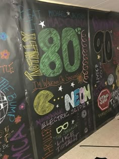 the chalkboard wall is decorated with many different writing styles and colors, including 80