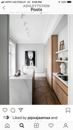 a kitchen with white walls and wood flooring