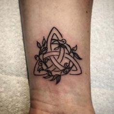 a black and white tattoo design on the ankle, with an intertwined knot in the middle