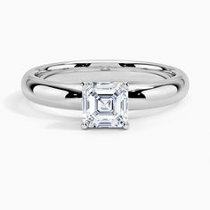 a white gold ring with an emerald cut diamond