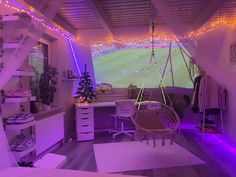 a bedroom with purple lights and a hammock hanging from the ceiling in front of a window