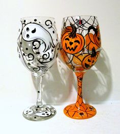 two wine glasses decorated with halloween decorations