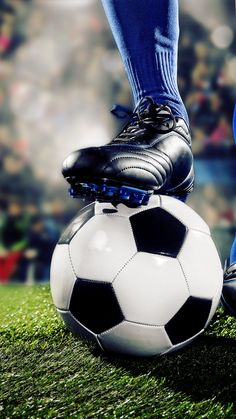 a person standing on top of a soccer ball