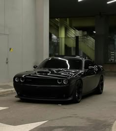 a black sports car parked in a parking garage