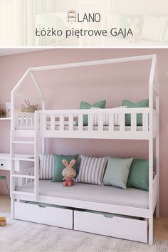 a white bunk bed sitting next to a window