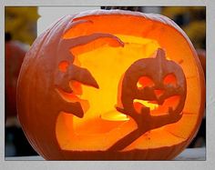 two pumpkins with faces carved into them