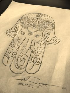 an elephant drawn on top of a piece of paper