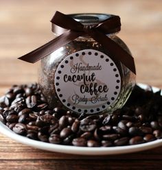 a jar filled with coffee beans sitting on top of a wooden table next to a plate