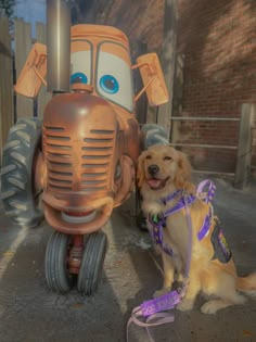 a dog sitting next to a toy truck