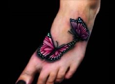 a foot with a butterfly tattoo on it