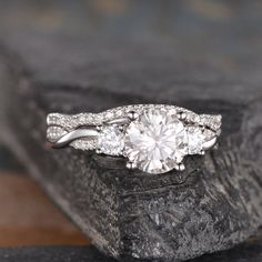 a close up of a diamond ring on a rock