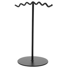 a black metal stand with two hooks on it's sides and one hook in the middle