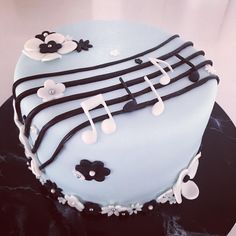 a cake decorated with music notes and flowers