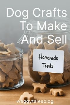 two glass jars filled with homemade dog treats on top of a wooden table next to a sign that says, dog crafts to make and sell