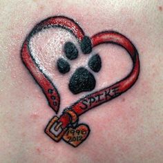 a dog paw and heart tattoo on the back of a woman's chest,