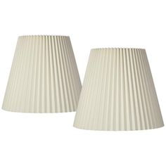 two white pleated lampshades sitting next to each other on a white background