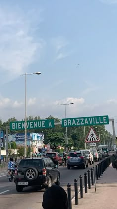 cars are driving down the street in front of an entrance to brazzavillee