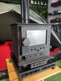 a black stove top oven sitting inside of a tent