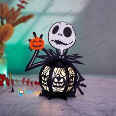 a halloween lantern with a jack - o'- lantern on it and a pumpkin in the background