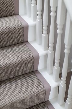 a close up view of some stairs with carpet on the bottom and bottom handrails