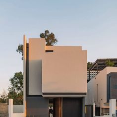 two people are standing in the doorway of a modern house