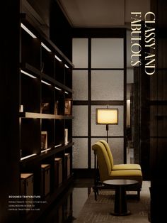 a yellow chair sitting in front of a book shelf next to a table with a lamp on it