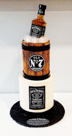 a cake made to look like a barrel with two bottles on top and one bottle in the middle