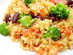 a white plate topped with rice, beans and broccoli