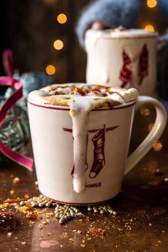 two mugs filled with hot chocolate and whipped cream