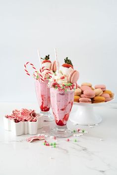 two glasses filled with ice cream and candy canes on top of a white table