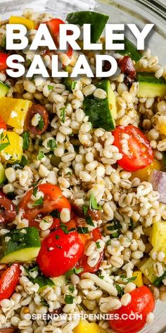 barley salad with tomatoes, cucumbers, and other vegetables in a glass bowl