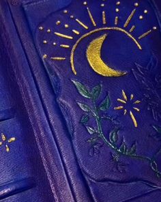 a purple book with the sun and moon painted on it